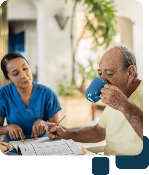 caregiver and client talk while drinking coffee