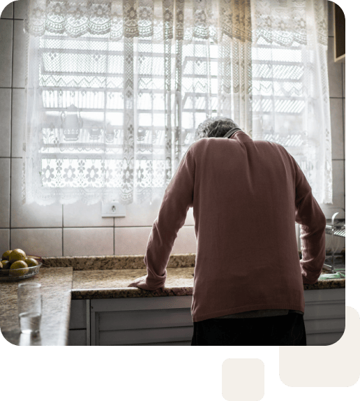 elderly man standing alone in kitchen