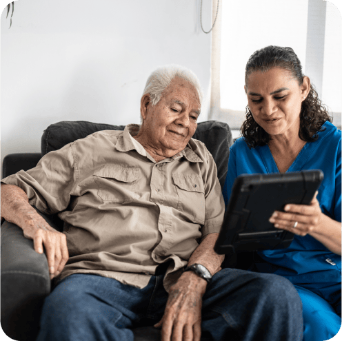caregiver helping elderly client with tablet-2